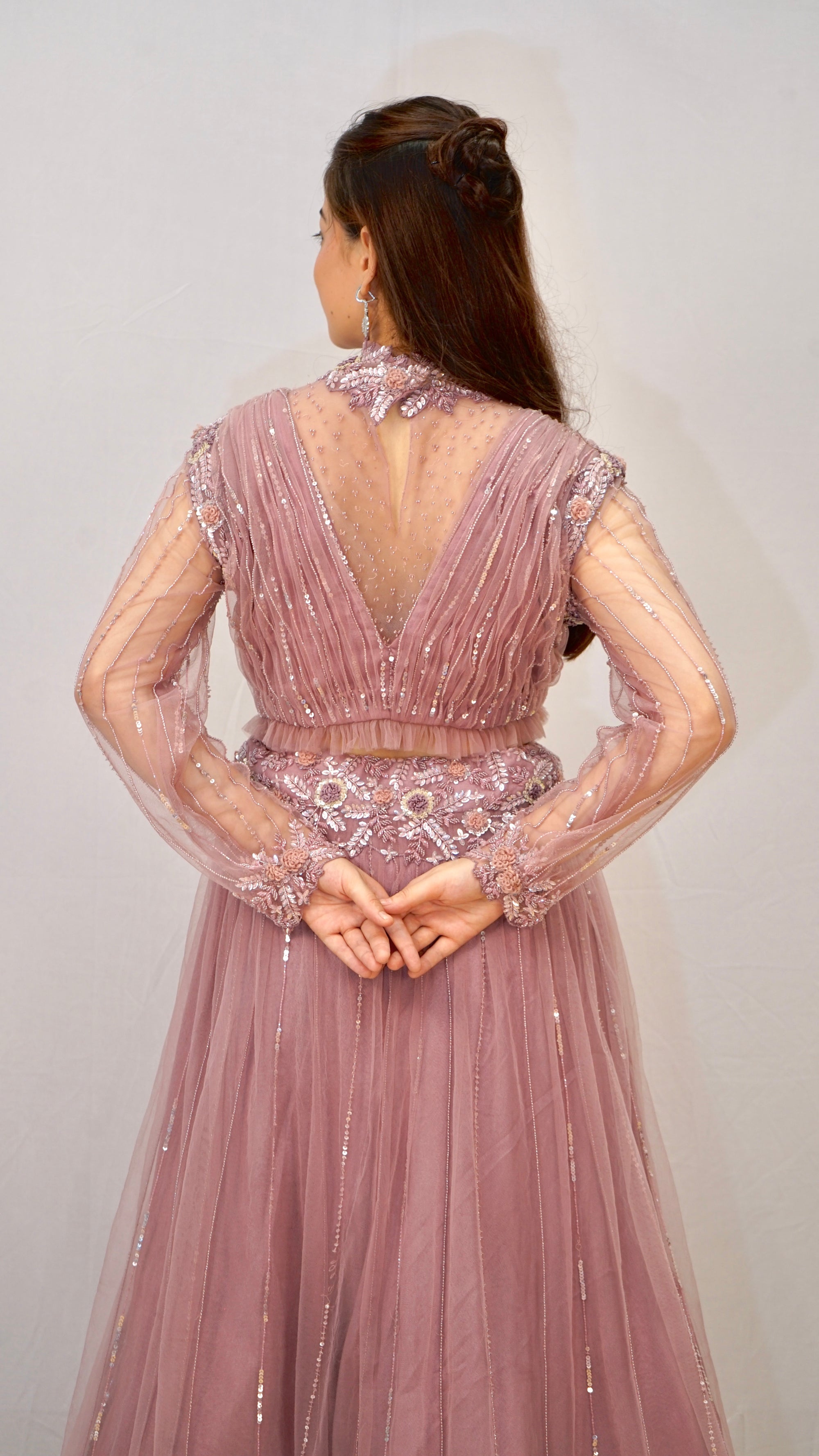 Purple turtle neck blouse with heavy net lehenga